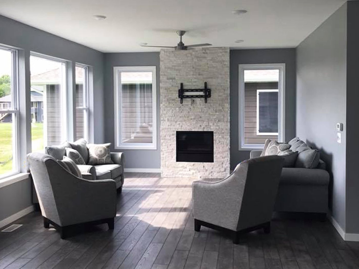 SGA Construction new home interior with fire place and grey furniture